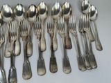 a lot of silver spoons and spoon spoons on a table
