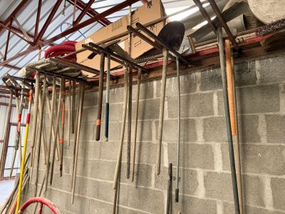 a lot of tools that are hanging up on the wall