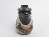 a black and white vase with a picture of people on it
