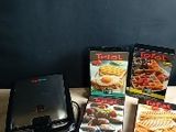 several boxes of food sitting on top of a table next to a laptop