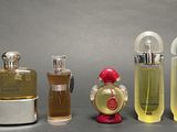 several different types of perfume bottles are lined up on a table