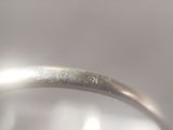 a close up of a silver ring with a diamond on it