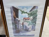 aquarelle encadrée représentant une scène de rue avec des bâtiments et des arbres