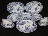a group of blue and white plates and cups
