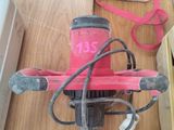 une personne debout sur un parquet, avec un vélo rose
