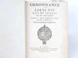 an old book with a picture of a coat of arms on it