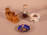 three small vases and a small bowl on a table