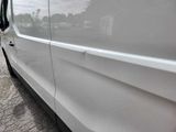 a white van that is parked on the side of the road