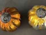 two pumpkins that are sitting on a table