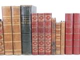 many old books lined up in a row on a white surface