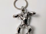 a silver keychain with a figure of a man on it
