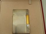 a lighter in a box with a pen in it