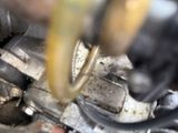 a close up view of a car engine with a hose