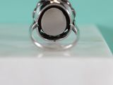 a silver ring with a black stone in it