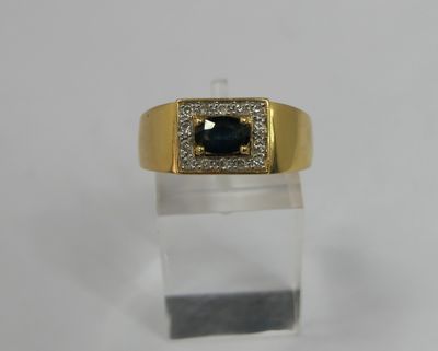 a close up of a gold ring with a blue stone in it