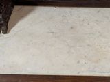 a marble floor with a wooden frame in the middle of it