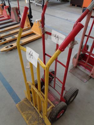a hand truck with a sign on it in a warehouse