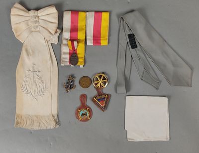 an assortment of items including a tie, medal, and other items