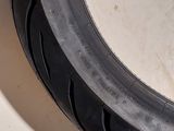 a close up of a motorcycle tire on a white surface