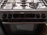 a stove that is sitting on a pallet in a room
