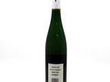the bottle of wine is sitting on a white surface