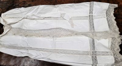 a white dress on a table with a pair of scissors