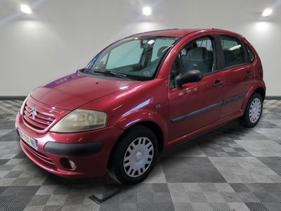 a picture of a red car parked on a checkered floor