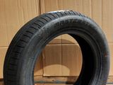 tire on the floor next to a cardboard box with a cardboard box in the background