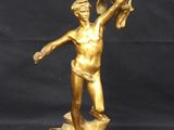 bronze statue of a woman holding a bird in her hand