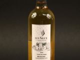 a bottle of white wine sitting on top of a table
