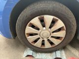 a blue car that has a flat tire on it