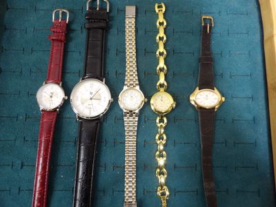several different types of watches are displayed in a display case