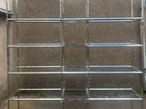 a metal shelf that has a lot of shelves on it