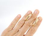 a woman ' s hand with two gold rings on it