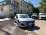 a silver audi parked in front of a building