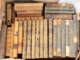 many old books in a box on the floor