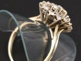 a close up of a diamond ring on a clear glass plate