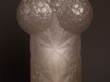 a frosted glass vase on a wooden table