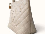 a chanel bag that is sitting on a white surface