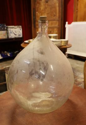 a glass bottle sitting on top of a wooden table