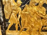 a gold and black marble box with a picture of a man and a woman