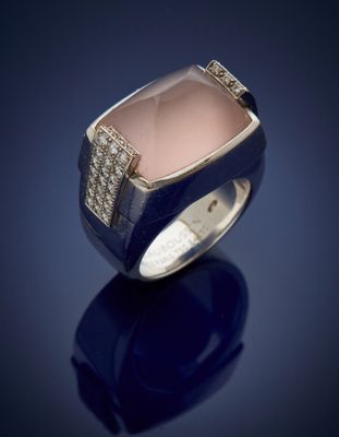 a close up of a ring with a pink stone and diamonds