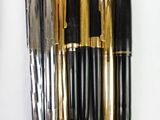 five different types of pens lined up on a white surface