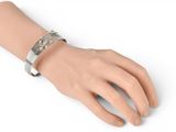a close up of a person ' s hand with a bracelet on it