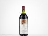 a bottle of red wine sitting on top of a table