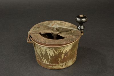 an old wooden bucket with a metal handle on a table