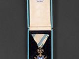 an image of a medal in a blue box on a black surface