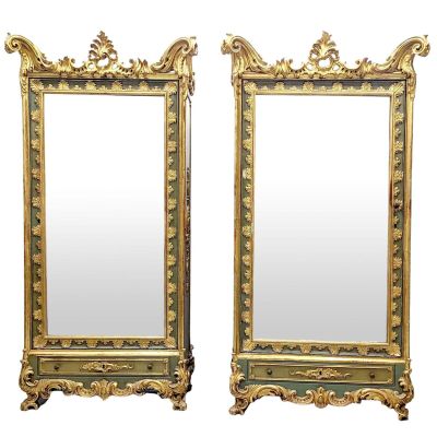 pair of antique mirrors with gold and green paint on the sides