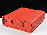 a red suitcase sitting on a white table