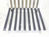 a white and black striped chair sitting on a white surface